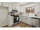 Stylish kitchen boasting white cabinets, stainless steel appliances, quartz countertops, and modern subway tile backsplash at 1628 Links Overlook, Stone Mountain, GA 30088