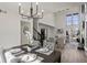 Open-concept living and dining area with hardwood floors, a modern chandelier, and an abundance of natural light at 1628 Links Overlook, Stone Mountain, GA 30088