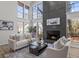 Bright living room with a fireplace, tall windows, and hardwood floors at 1628 Links Overlook, Stone Mountain, GA 30088