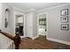 Upstairs hallway features wood-look flooring, crown molding, and access to laundry and bedroom at 2800 Georgian W Dr, Brookhaven, GA 30341