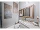 Elegant bathroom features tasteful wall decor, a modern sink, and framed mirror to compliment this relaxing space at 4916 Kentwood Dr, Marietta, GA 30068