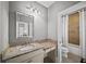 Bathroom featuring a granite countertop, vanity, modern fixtures, and tub with tile surround and shower at 4916 Kentwood Dr, Marietta, GA 30068