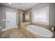 Bright and spacious bathroom featuring a soaking tub and a glass-enclosed shower with upscale finishes at 4916 Kentwood Dr, Marietta, GA 30068