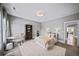Well-lit bedroom with a large bed, windows, a bookshelf, and an ensuite bathroom with modern finishes at 4916 Kentwood Dr, Marietta, GA 30068