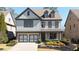 Charming two-story home with a two-car garage, covered porch, brick accents, and landscaped front yard at 4916 Kentwood Dr, Marietta, GA 30068