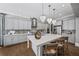 A stylish kitchen boasts an island with seating, pendant lighting, stainless steel appliances, and light gray cabinets at 4916 Kentwood Dr, Marietta, GA 30068