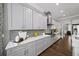 A modern kitchen featuring gray cabinetry, quartz countertops, stainless steel appliances, and hardwood flooring at 4916 Kentwood Dr, Marietta, GA 30068