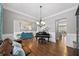 Elegant living room with hardwood floors, piano, and modern chandelier at 4916 Kentwood Dr, Marietta, GA 30068