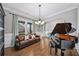 Elegant living room featuring a grand piano, leather sofa, and stylish decor, perfect for entertaining guests at 4916 Kentwood Dr, Marietta, GA 30068