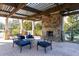 Inviting outdoor patio with stone fireplace, pergola, and comfortable seating at 4916 Kentwood Dr, Marietta, GA 30068
