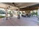 Covered outdoor patio with stone fireplace, ceiling fans, and comfortable seating at 4916 Kentwood Dr, Marietta, GA 30068