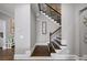Elegant staircase with wood treads and iron spindles, enhancing the home's architectural appeal and style at 4916 Kentwood Dr, Marietta, GA 30068