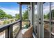 This covered outdoor balcony features a cozy seating area with two stylish woven chairs at 525 Burlrush Ln # 16, Alpharetta, GA 30009