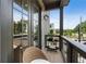 Cozy outdoor balcony with a woven chair and table, perfect for enjoying the outdoors at 525 Burlrush Ln # 16, Alpharetta, GA 30009