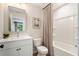 Clean bathroom featuring a white vanity, toilet, shower/tub, and a neutral color palette at 525 Burlrush Ln # 16, Alpharetta, GA 30009
