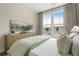 Relaxing bedroom featuring a large window, dresser, and comfortable bed with neutral bedding at 525 Burlrush Ln # 16, Alpharetta, GA 30009