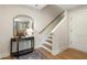 Entryway area featuring a staircase, a table with mirror, and hardwood floors at 525 Burlrush Ln # 16, Alpharetta, GA 30009
