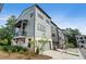 Modern townhome with gray siding, balconies, two-car garage, and front yard landscaping at 525 Burlrush Ln # 16, Alpharetta, GA 30009