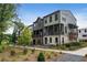 Modern townhome with dark gray siding, balconies, brick accents, and professional landscaping at 525 Burlrush Ln # 16, Alpharetta, GA 30009