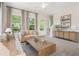 Cozy living room featuring a comfortable sofa, large windows, and a stylish console table at 525 Burlrush Ln # 16, Alpharetta, GA 30009
