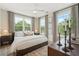 Bright main bedroom featuring three large windows with leafy green tree views at 525 Burlrush Ln # 16, Alpharetta, GA 30009