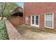 Brick home exterior with a concrete patio and elevated deck overlooking the backyard at 2914 Stanway Ave, Douglasville, GA 30135