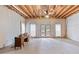 Unfinished basement with an exposed wood ceiling, concrete floors, and a set of double doors to the backyard at 2914 Stanway Ave, Douglasville, GA 30135