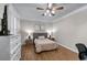 Cozy bedroom with hardwood floors, ceiling fan, and neutral decor for a relaxing space at 2914 Stanway Ave, Douglasville, GA 30135