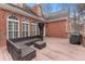 Outdoor living space features wicker sofa and glass table, great for relaxing and entertaining at 2914 Stanway Ave, Douglasville, GA 30135