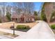 Long driveway leads to a beautiful brick home with well-maintained landscaping and mature trees at 2914 Stanway Ave, Douglasville, GA 30135