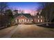 Charming brick home with mature trees, manicured lawn, and a welcoming walkway to the front porch at 2914 Stanway Ave, Douglasville, GA 30135
