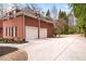 Detached two-car garage with a wide driveway and tidy landscaping, and brick facade at 2914 Stanway Ave, Douglasville, GA 30135