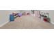 Playroom area with a play kitchen, shelving, and neutral carpeting at 2914 Stanway Ave, Douglasville, GA 30135