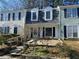Inviting townhomes featuring dormer windows, dark shutters, and stone paver front patios at 3228 Shadow Walk Ln, Tucker, GA 30084