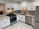 Bright kitchen featuring white cabinets, stainless steel appliances, and granite countertops at 3228 Shadow Walk Ln, Tucker, GA 30084