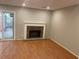 Cozy living room features a classic brick fireplace and sliding door access to the outdoors at 3228 Shadow Walk Ln, Tucker, GA 30084