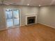 Bright living room with fireplace, wood floors, and sliding glass doors to outdoor patio at 3228 Shadow Walk Ln, Tucker, GA 30084