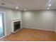 Well-lit living room featuring a fireplace, wood floors, and sliding glass doors to the patio at 3228 Shadow Walk Ln, Tucker, GA 30084