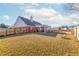 The fenced backyard features a spacious lawn and covered patio at 502 Stoneland Pl, Lawrenceville, GA 30046
