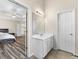 Bathroom features a vanity with modern light fixtures and a full bedroom suite view at 502 Stoneland Pl, Lawrenceville, GA 30046