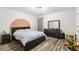 Bedroom features a large bed, dark furniture, and stylish flooring, creating a modern and comfortable living space at 502 Stoneland Pl, Lawrenceville, GA 30046