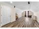 A large bonus room featuring wood laminate floors and natural lighting creating a versatile space at 502 Stoneland Pl, Lawrenceville, GA 30046