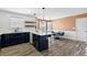 Kitchen featuring white backsplash, a large island with eat at seating, stainless steel appliances, and dining nook at 502 Stoneland Pl, Lawrenceville, GA 30046