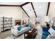 Open-concept living room featuring exposed beams, a brick fireplace, and comfortable seating at 502 Stoneland Pl, Lawrenceville, GA 30046