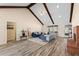 Bright living room with vaulted ceiling, exposed beams, fireplace, and gray and blue furniture at 502 Stoneland Pl, Lawrenceville, GA 30046