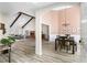 Open-concept living room featuring a brick fireplace, vaulted ceiling, and seamless flow to the dining area at 502 Stoneland Pl, Lawrenceville, GA 30046