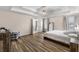 Spacious main bedroom featuring a tray ceiling, ceiling fan, an ensuite bath and luxury vinyl plank flooring at 502 Stoneland Pl, Lawrenceville, GA 30046
