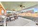 The covered patio is equipped with a ceiling fan, a grill and comfortable seating area at 502 Stoneland Pl, Lawrenceville, GA 30046