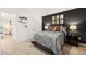 Bedroom with a dark accent wall, neutral carpet, and decorative wall art at 5429 Flat Rock Point, Stonecrest, GA 30038