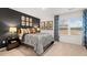 Bedroom with a dark accent wall, large window and stylish decor at 5429 Flat Rock Point, Stonecrest, GA 30038